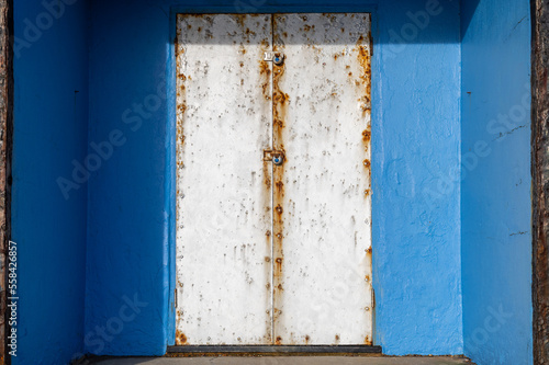 Blue beach hut with silver metal doors at Bexhill-on-Sea, East Sussex, England