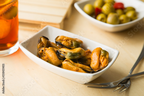 Pickled mussels tapa with a glass of vermouth in Spain. photo
