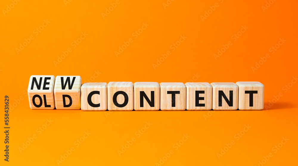 New or old content symbol. Concept words New content and Old content on wooden cubes. Beautiful orange table orange background. Business New or old content concept. Copy space.