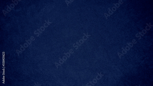 Dark blue velvet fabric texture used as background. Tone color blue cloth background of soft and smooth textile material. There is space for text and for all types of design work..
