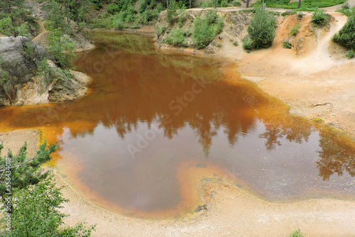 A view of a purple lakelet in Rudawy Janowickie, Sudetes mountains, Poland, a mining excavation flooded with water
