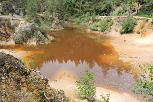 A view of a purple lakelet in Rudawy Janowickie, Sudetes mountains, Poland, a mining excavation flooded with water