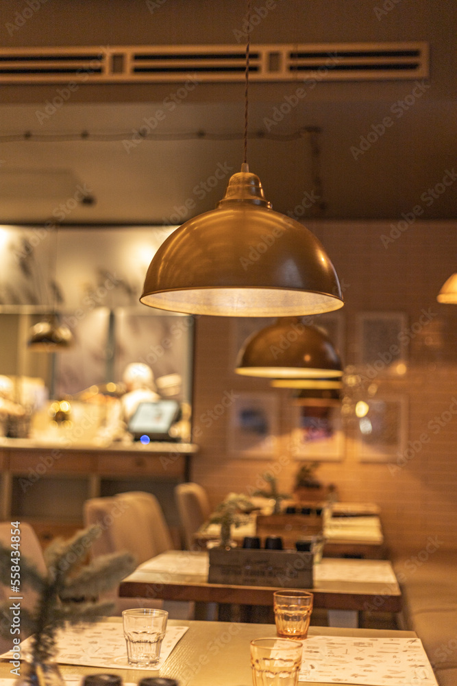 Café interior. Empty tables, lamps in a café Café interior. Empty tables, lamps in a café