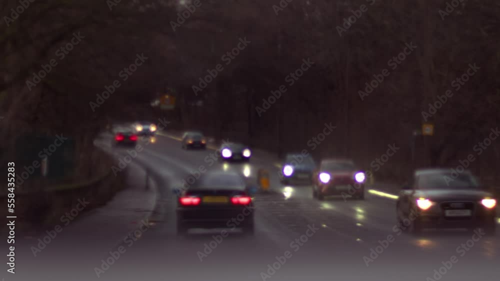 Traffic on British highway with ambulance through view of passenger windscreen Traffic on British highway with ambulance through view of passenger windscreen