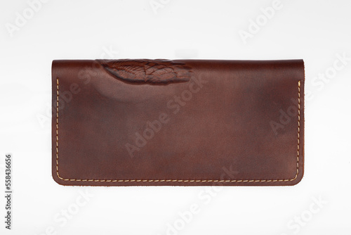 Big brown leather wallet on a button on a white background, owl print. Top view