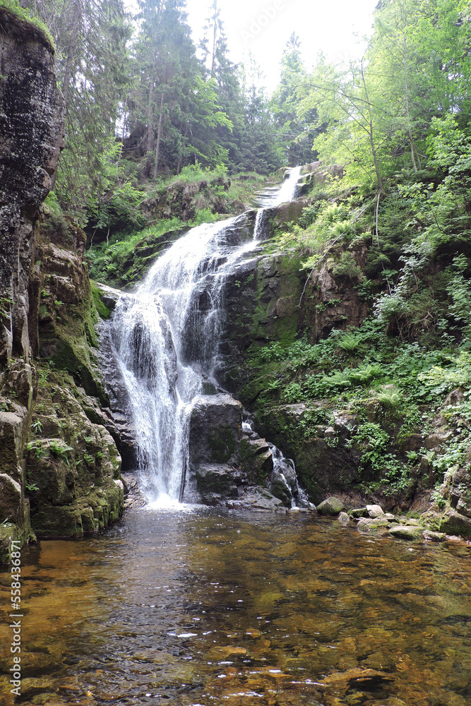 Fototapeta premium Kamieńczyk Waterfall, the highest waterfall in the Polish part of The Karkonosze Mountains falling from a rocky wall to the Kamieńczyk Gorge