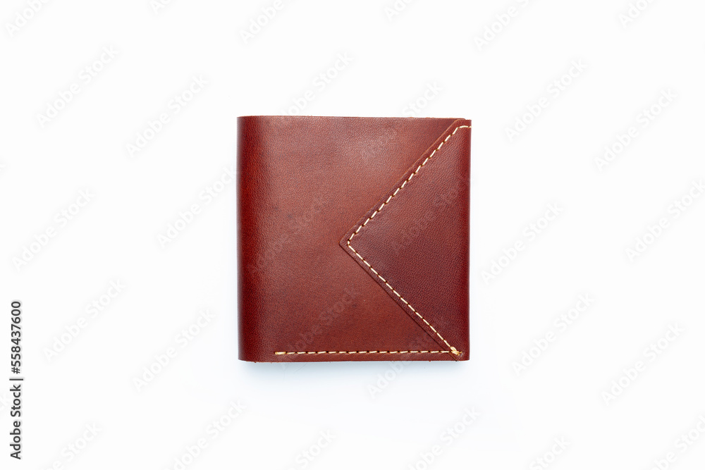Small brown leather wallet on a button on a white background. Top view Small brown leather wallet on a button on a white background. Top view