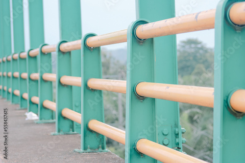 an iron bridge with yellow paint that looks a little peeling.