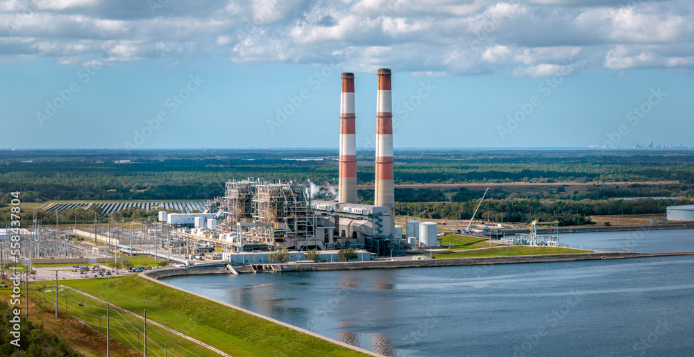 Obraz premium Power Plant in West Coast, Florida with St. Petersburg city skyline visible in the background. Jan 3, 2022