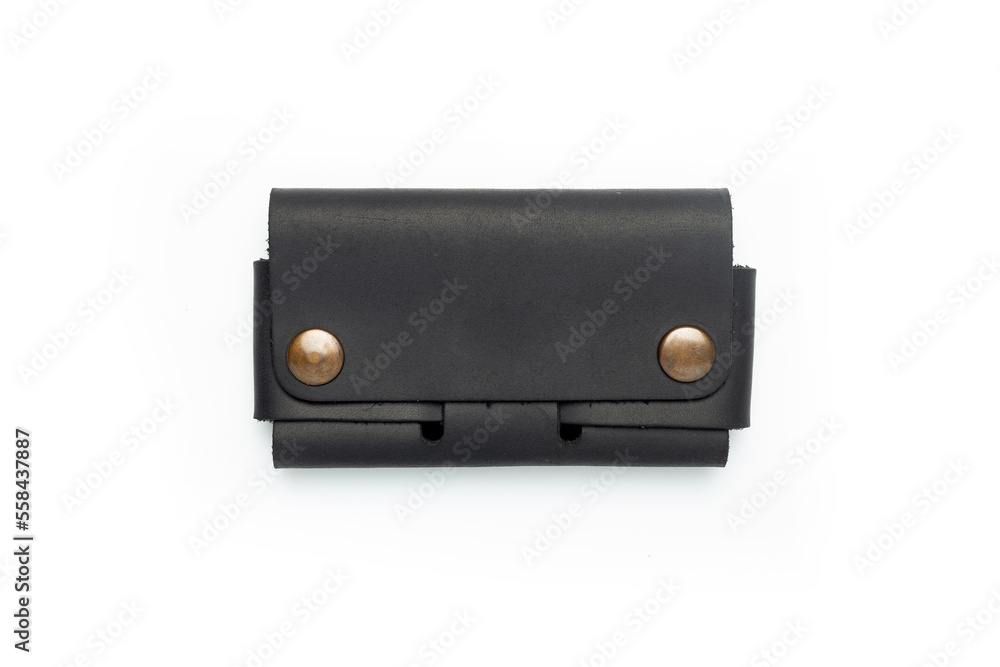 Naklejka premium Small black leather wallet on a button on a white background. Top view