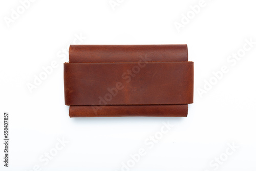 Small brown leather wallet on a buttons on a white background. Top view