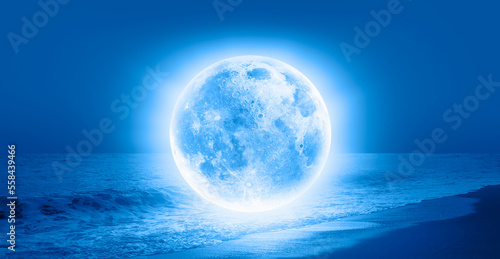 Fantasy landscape - Full Moon on the sea coast with blue sea  Elements of this image furnished by NASA 