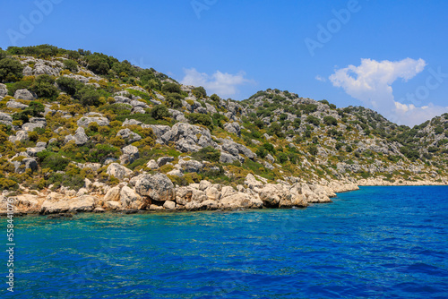 View of the rocky shore from the sea. Mediterranean Sea in Turkey. Popular tourist places. Background