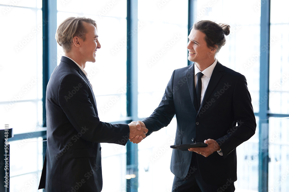 businessman shaking hands with friends and having fun in the office businessman shaking hands with friends and having fun in the office