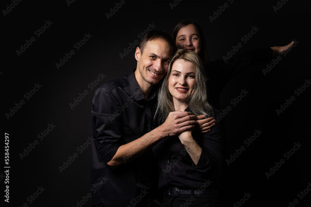 happy family mother, father, daughter on a black background happy family mother, father, daughter on a black background