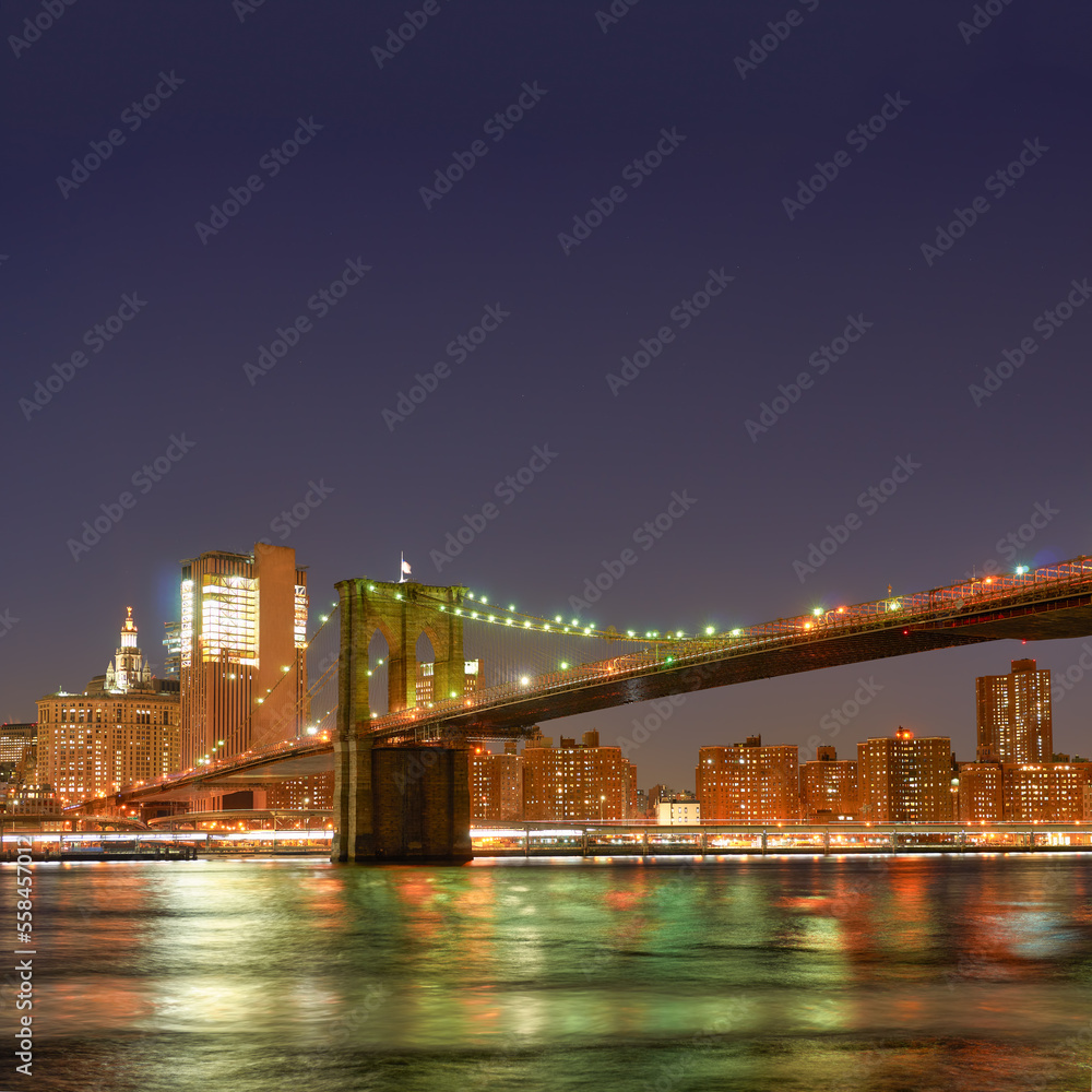 View of Brooklin Bridge in New York City at night.