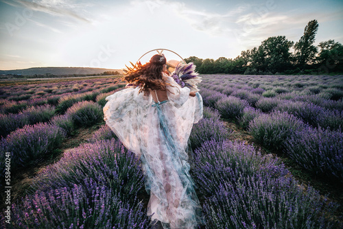 Beautiful bride in a lavender field at sunset.  photo