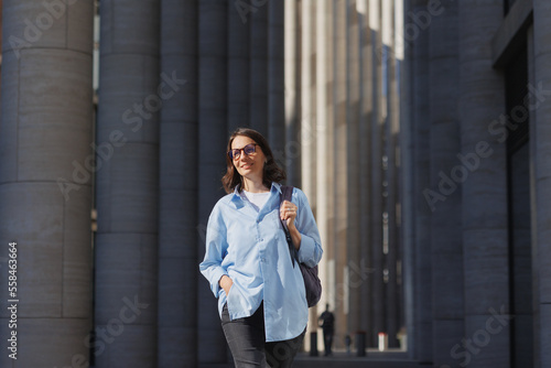 Wallpaper Mural portrait successful business woman with glasses goes office work or to meeting outdoor partners. confident lady in blue shirt smiles. entrepreneur startup and small business, modern female financier Torontodigital.ca