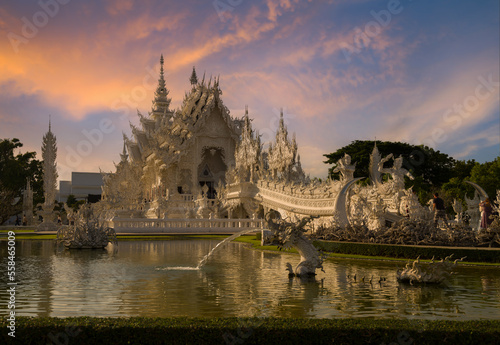 Wat Rong Khun or White Temple at sunset. It is the most important travel destination in Chiang Rai province. Northern Thailand