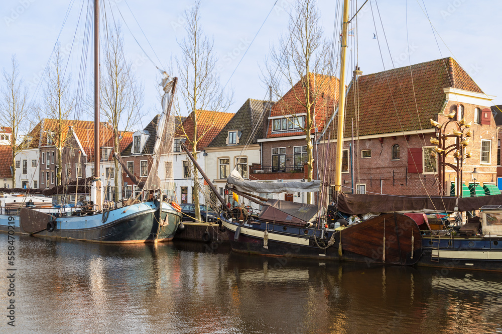 Historic sailboats moored in the harbor of the Dutch city of Weesp.