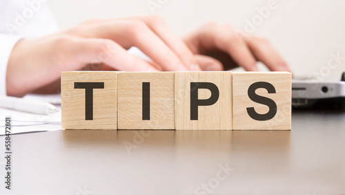 man made word TIPS with wood blocks on the background of the office table. selective focus. business concept.