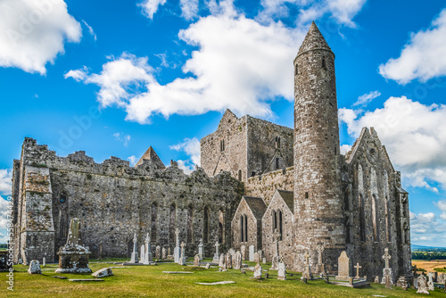 Ruins of the medieval old huge cathedral among tombstones on Rock of Cashel, Ireland