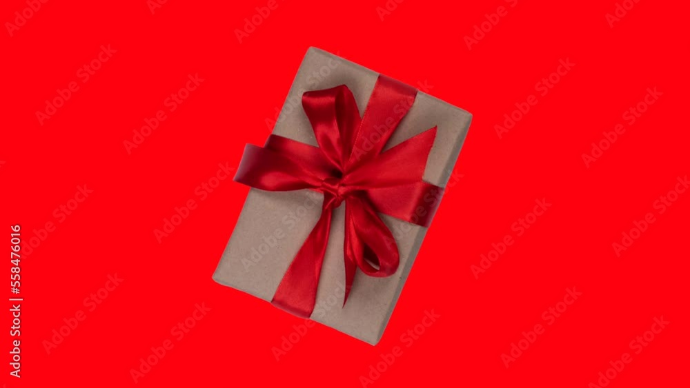 Animation of a rotating and approaching gift box with a red bow on a red background, the concept of valentine's day or other holidays Animation of a rotating and approaching gift box with a red bow on a red background, the concept of valentine's day or other holidays