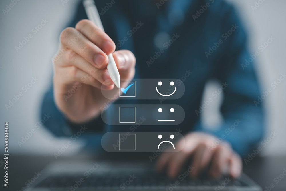 Customer service and Satisfaction concept ,feedback customer. Business people are touching virtual screen on the happy Smiley face icon to give satisfaction in service. rating very impressed. Customer service and Satisfaction concept ,feedback customer. Business people are touching virtual screen on the happy Smiley face icon to give satisfaction in service. rating very impressed.