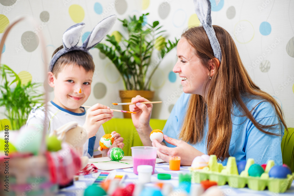 Happy Easter. A mother and her son painting Easter eggs Happy Easter. A mother and her son painting Easter eggs