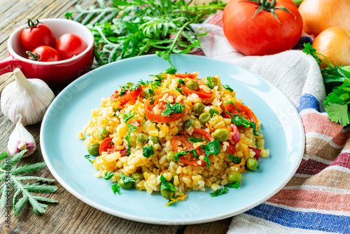 Bulgur with carrots, onions, bell peppers and green peas
