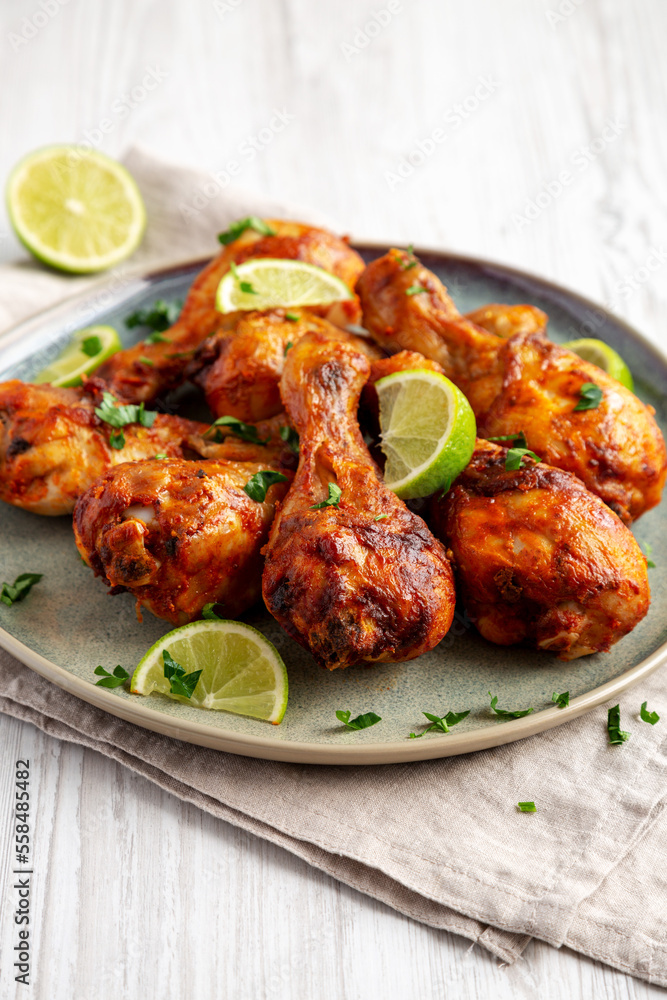 Homemade Grilled Jerk Chicken with Lime on a Plate, low angle view. Homemade Grilled Jerk Chicken with Lime on a Plate, low angle view.