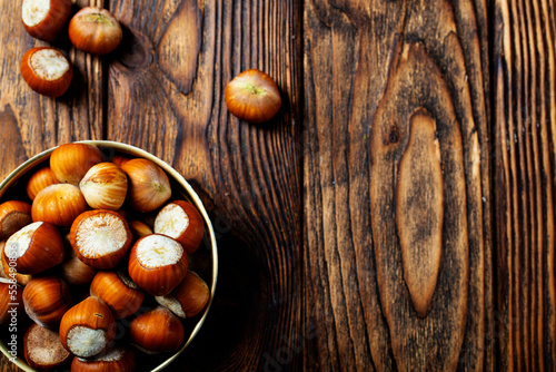 Hazelnuts on wooden backdrop. heap or stack of hazelnuts. Hazelnut background, healty food