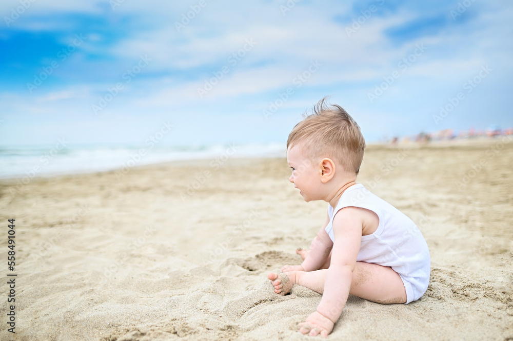 Happy little toddler boy portrait Playing With Sand in the beach Happy little toddler boy portrait Playing With Sand in the beach