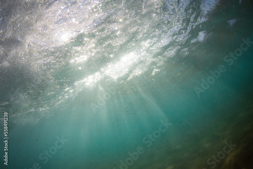 Beautiful sunlight rays under the water surface.