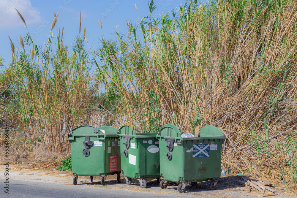Large garbage cans on the street, symbolizing the recycling of waste. waste tanks. Large garbage cans on the street, symbolizing the recycling of waste. waste tanks.