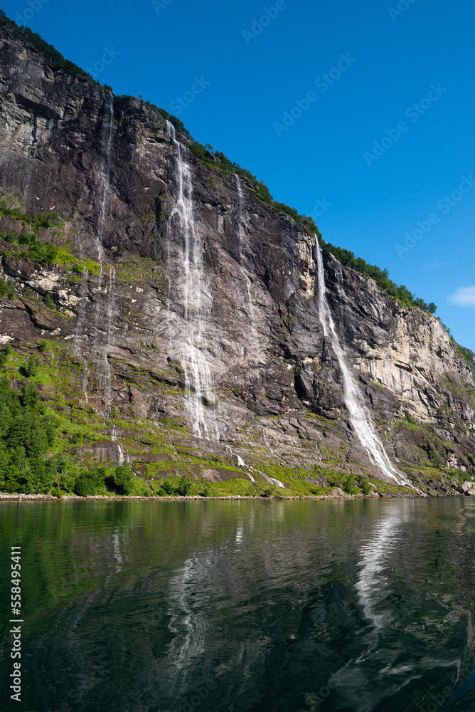 The famous and impressive Seven Sisters (Dei sju systre)  waterfall dropping 250 meters from a cliff in the Geiranger Fjord, Norway