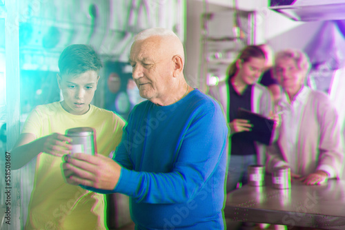 Grandson together with his grandfather solve the riddles of the quest room