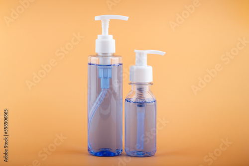 Sanitizers on a bright orange background.
