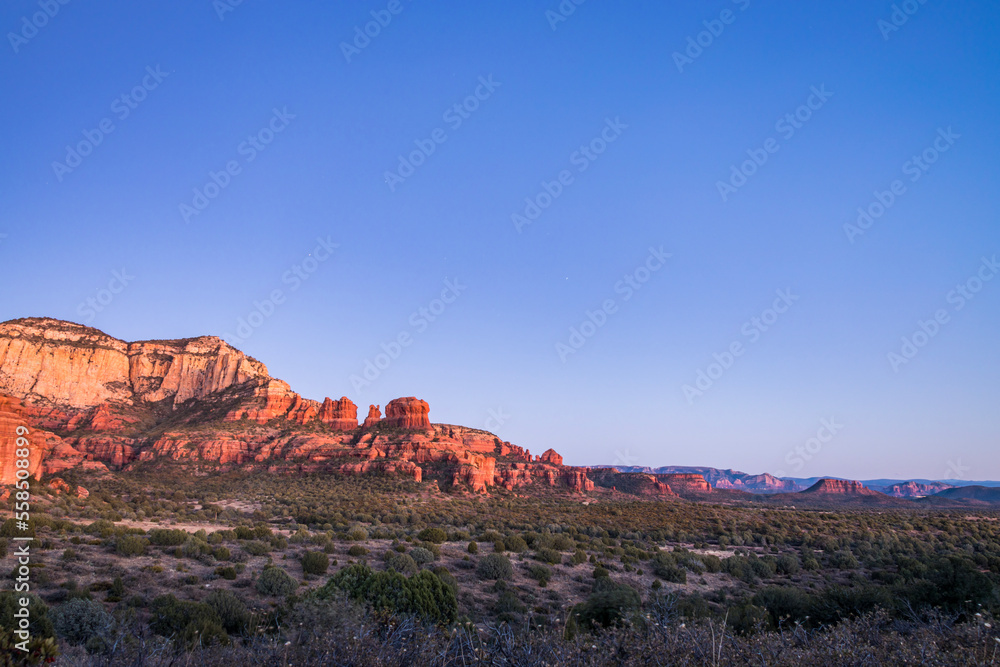 Naklejka premium At sunset, Bear Mountain can be seen in the distance from the Red Rock-Secret Mountain Wilderness, which is located in Yavapai County, Arizona and is part of the Coconino National Forest. 