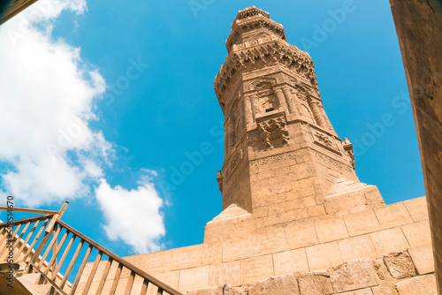 Low angle view of minaret of Zuwayla Door against cloudscape, Cairo, Egypt photo