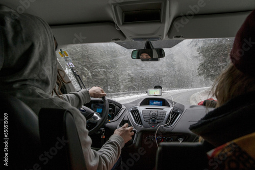 Man and woman looking through car windshield during road trip in Eastern Europe photo