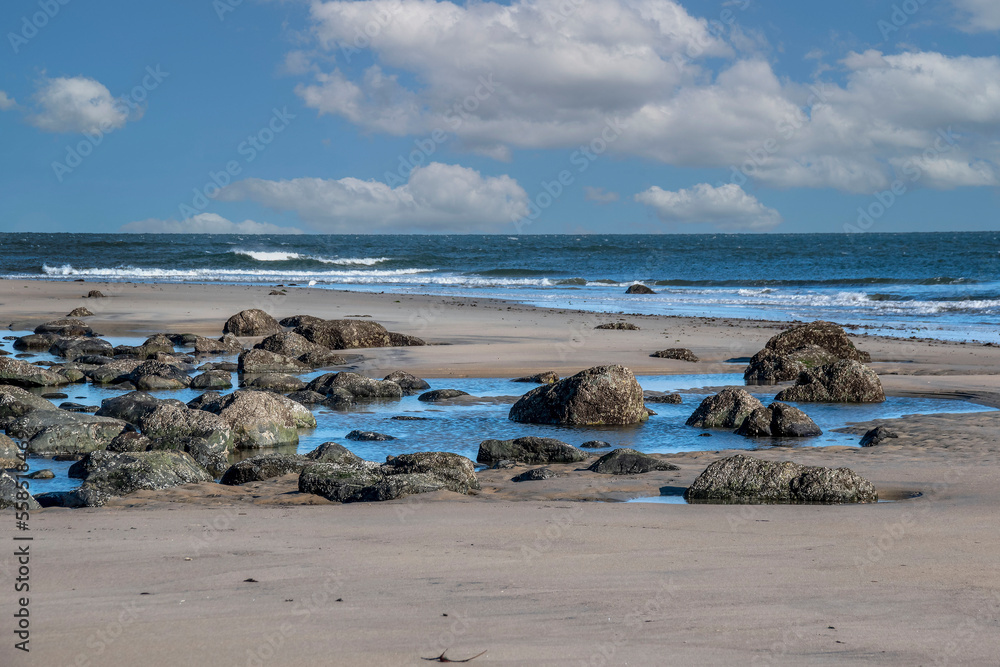 rocky shore of sandy point beach in ipswich massachussetts