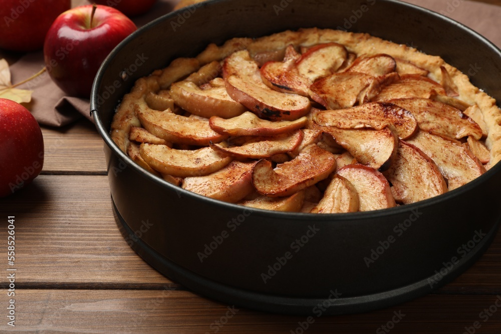 Delicious apple pie and fresh fruits on wooden table, closeup