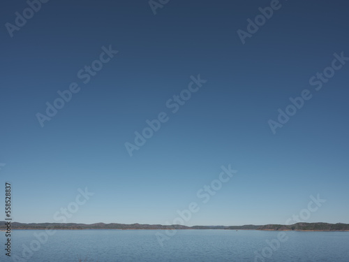 a clear blue sky over a still lake