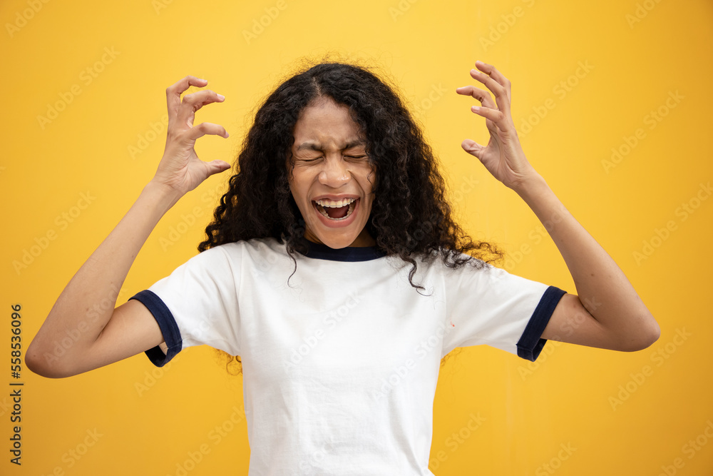 Angry and furious African American woman on a yellow background. She made an angry gesture with her hand. Angry and furious African American woman on a yellow background. She made an angry gesture with her hand.