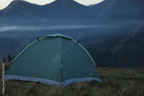 Camping tent in mountains on early morning