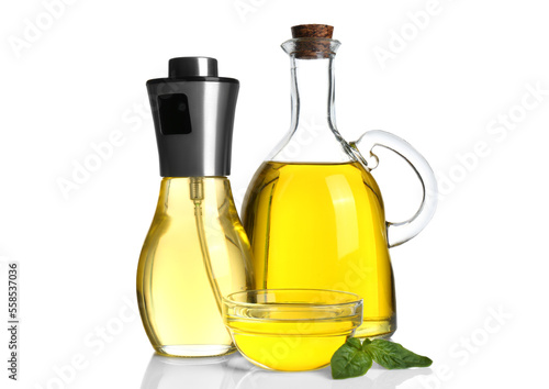 Cooking oil and basil leaves on white background