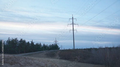 A thin power grid pole on a hill in the forest © Alexander Volokha
