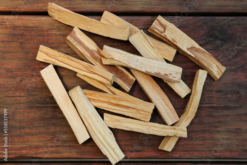 Many palo santo sticks on wooden table, flat lay