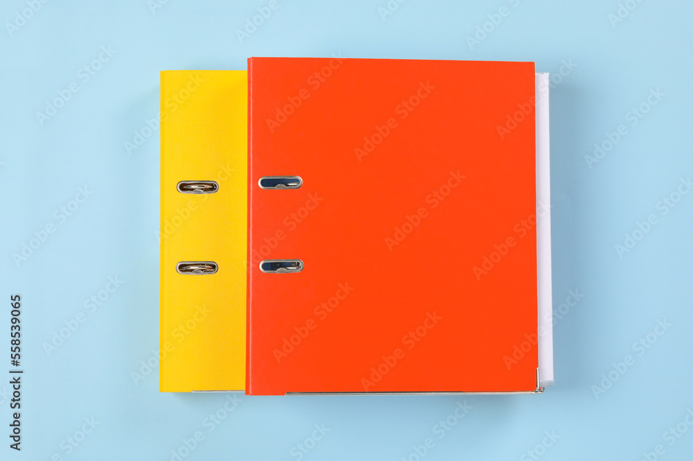Office folders on light blue background, flat lay Office folders on light blue background, flat lay
